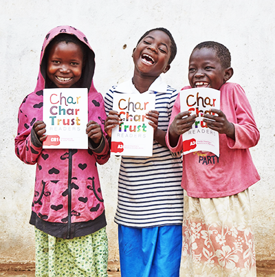Girls holding CharChar Trust books